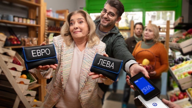 woman holding wallets and man paying with mobile