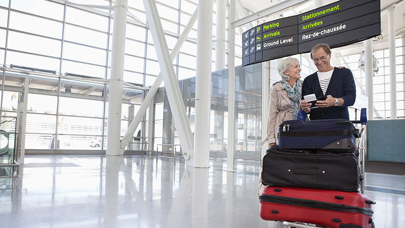 Smiling couple with full luggage trolley in airport. Smiling couple with full luggage trolley in airport.