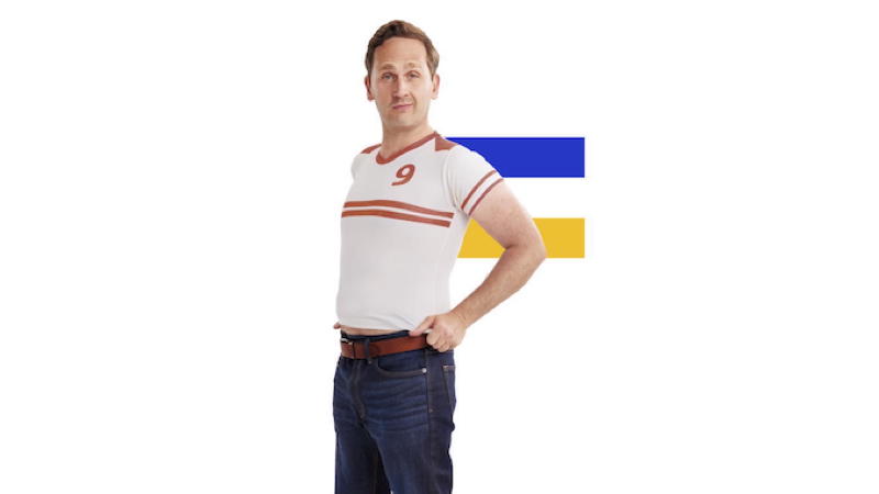 Man wearing football shirt in front of Visa logo