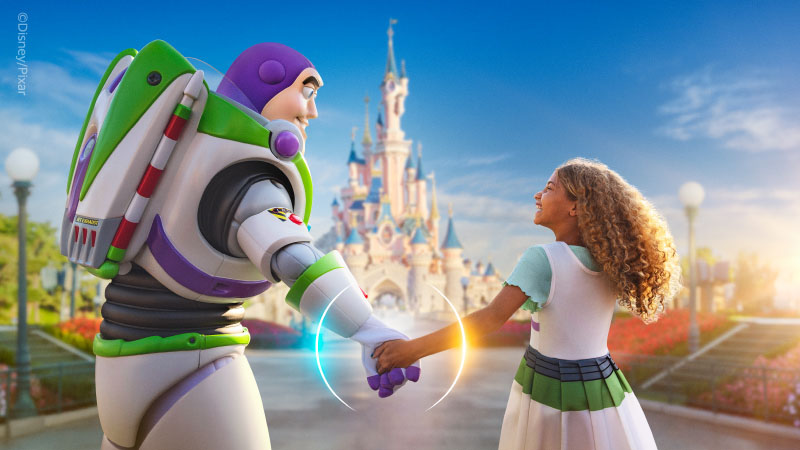 Buzz lightyear and child holding hands in front of disney castle