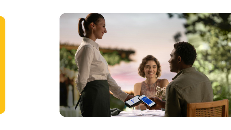 paying with Visa on phone in restaurant