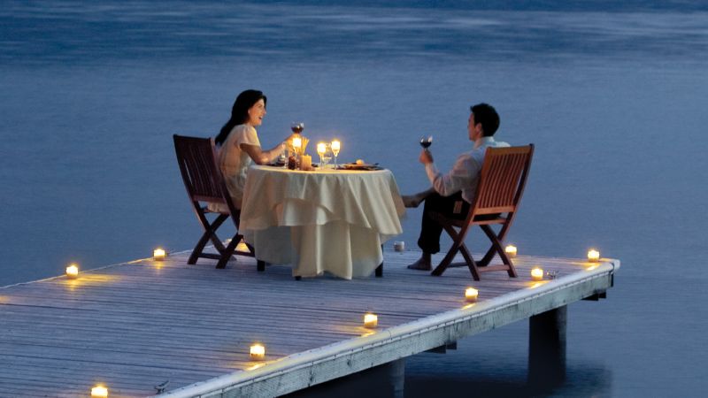 couple having dinner at pier