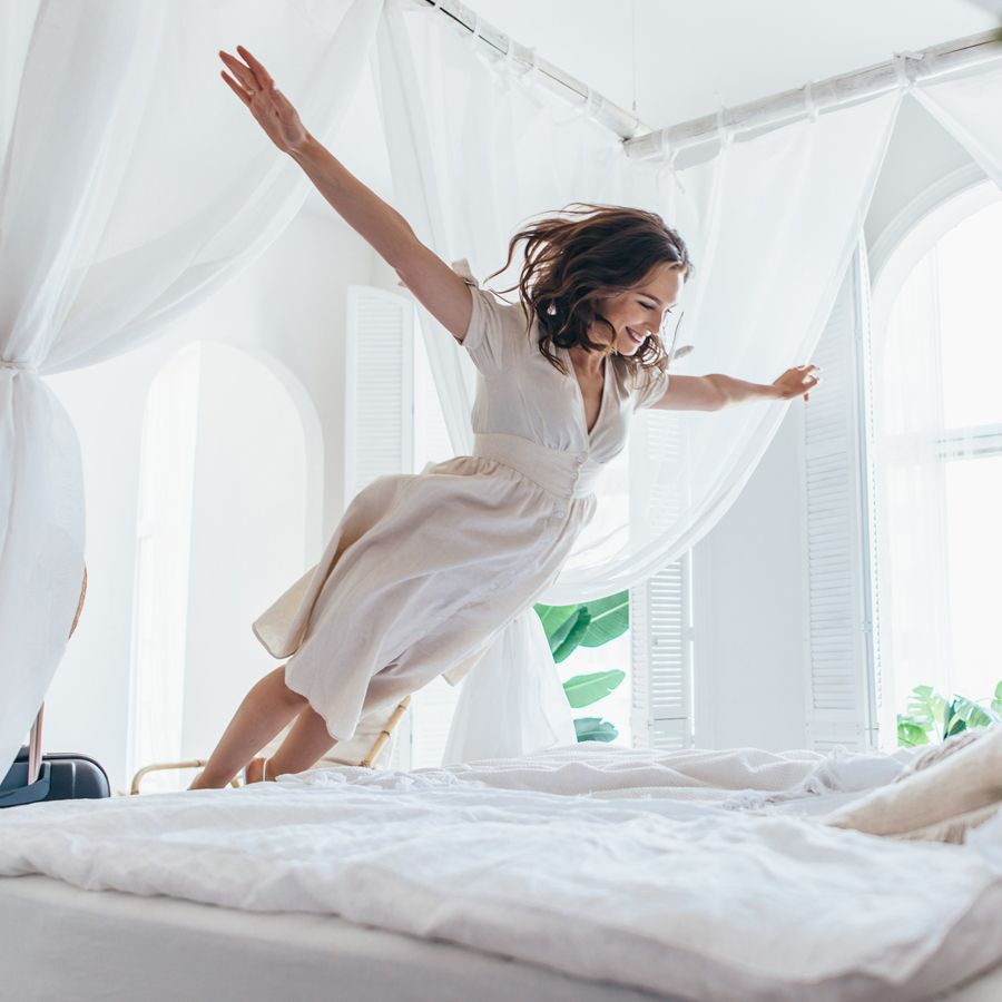 woman jumping into bed